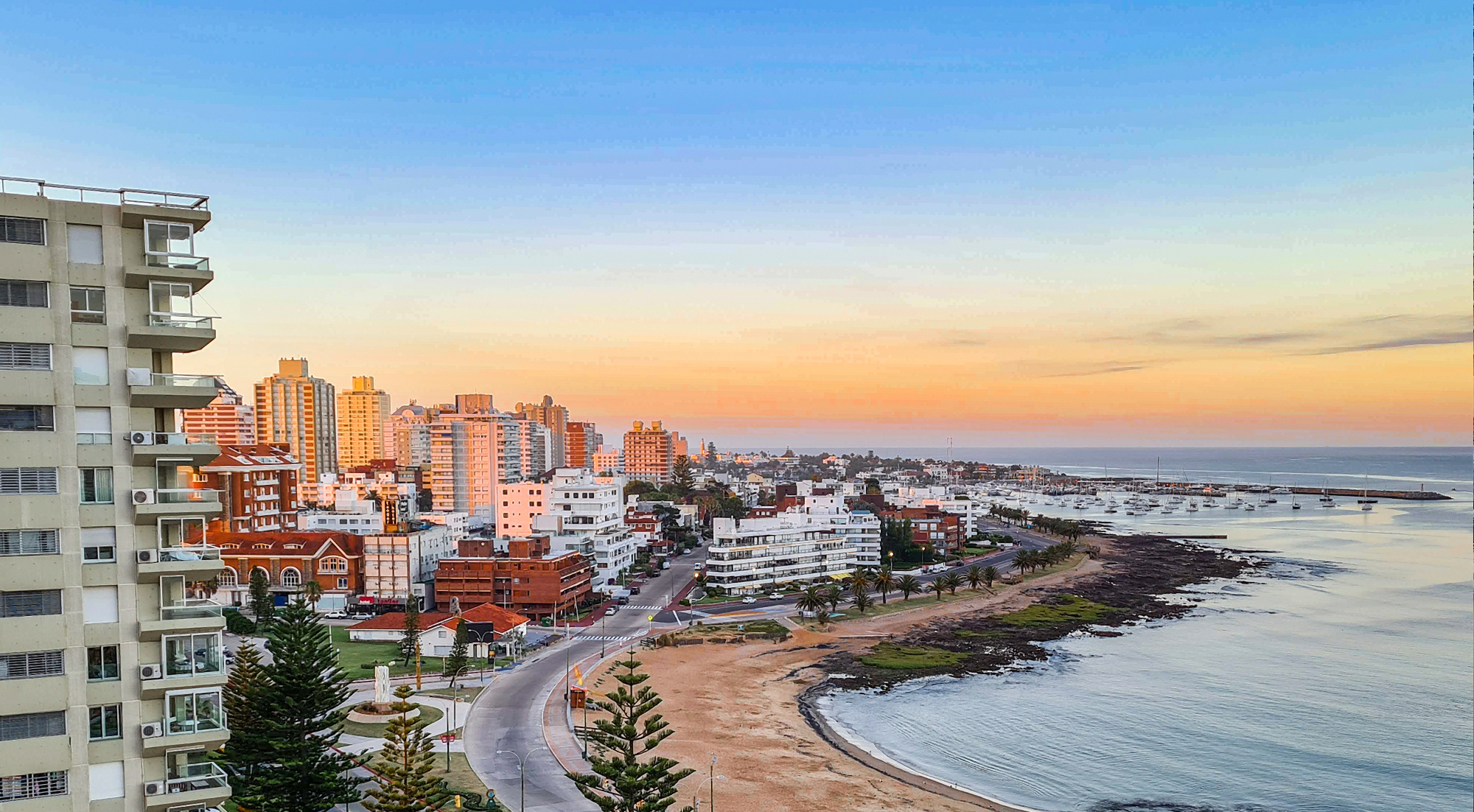 Küste und Stadt in Uruguay bei Sonnenuntergang